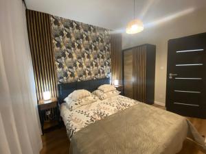 a bedroom with a bed with two pillows on it at Apartament Bristol in Mielec