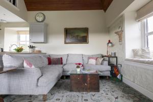 a living room with a couch and a table at The Bothy at Redheugh in Newcastleton