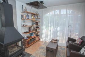 a living room with a fireplace and a couch at La Platjeta in Calonge