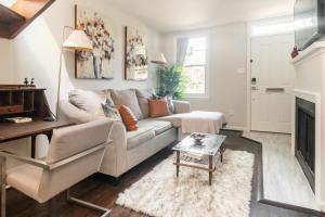 a living room with a couch and a fireplace at King Bed & Fenced Yard - Floyd's Freedom- in Alexandria