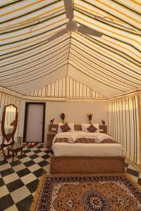 a bedroom with a large bed with a ceiling at Kesariya Heritage Resorts in Jaisalmer