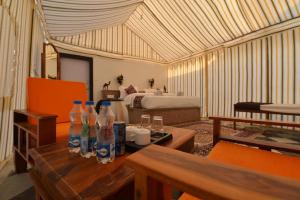 a room with bottles on a table with a bed at Kesariya Heritage Resorts in Jaisalmer