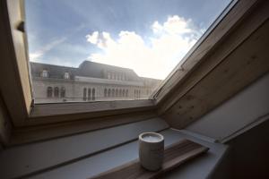 a cup sitting on a window sill with a view of a building at Fewo Charlotte in Weimar