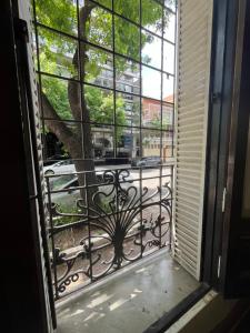 an open window with a view of a tree at Casa Próspera in Buenos Aires