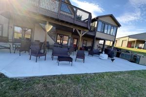 a patio in front of a house with chairs at Maple Brook Memories in Amanda