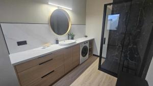 a bathroom with a sink and a washing machine at Heven in Ostrowiec +30 photos
