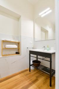 a bathroom with a sink and a mirror at Residenza La Donzella - Appartamento verde in Campobasso
