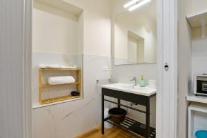 a bathroom with a sink and a microwave at Residenza La Donzella - Appartamento verde in Campobasso +4 photos