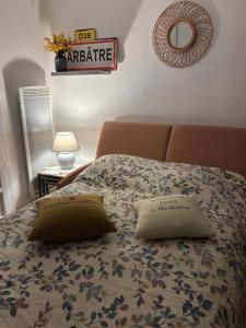 a bed with two pillows on it in a bedroom at L'Air Marin in Barbâtre