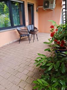 a patio with two chairs and a bench on a house at Ilonas Home in Baden-Baden
