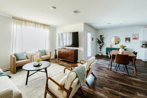 a living room with a couch and a table at 4br Modern Getaway - Mins To Ua, King Bed in Maxwell