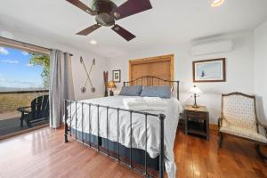 a bedroom with a bed and a ceiling fan at Sit Stay Play in Beech Mountain