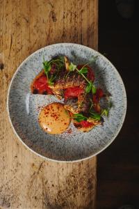 a plate of food with eggs on a wooden table at Bankes Arms Hotel in Wareham