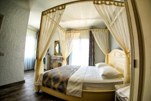 a bedroom with a canopy bed with a window at Villa Fanti in Çeşme