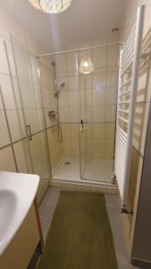 a bathroom with a shower with a glass door at Longère chez Martine et Julie in Romorantin