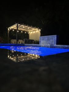a swimming pool with a pergola at night at Casa Anastasia Beachside Villa with Pool in Vieques