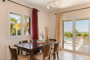 a dining room with a table and chairs at Dina by Vintage Travel in Kaligata