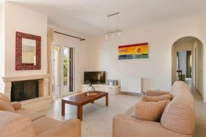 a living room with two couches and a fireplace at Dina by Vintage Travel in Kaligata