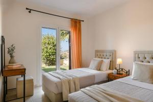 a bedroom with two beds and a large window at Dina by Vintage Travel in Kaligata +26 photos