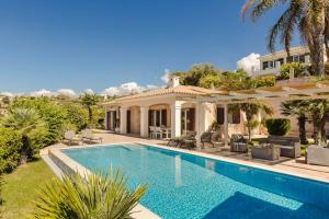 a swimming pool in front of a house at Dina by Vintage Travel in Kaligata