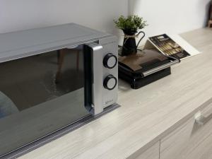 a microwave oven sitting on top of a counter at Monolocale vicino Pordenone Fiera 
