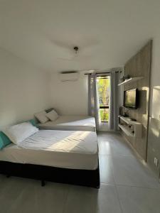 Ένα ή περισσότερα κρεβάτια σε δωμάτιο στο Apto com piscina aquecida em Riviera - Não aceita pet +29 φωτογραφίες