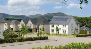 a row of houses with solar panels on their roofs at 3 bed spacious room in a new build house in Roslin