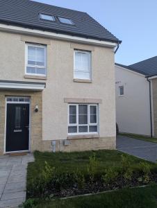 a brick house with a black door at Double Room Roslin Near Edinurgh City in Roslin