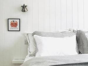 a bedroom with a bed and a picture on the wall at Shrimp Cromer in Cromer +15 photos