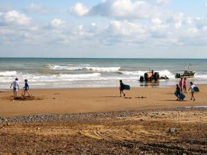 a group of people walking on the beach at Shrimp Cromer in Cromer