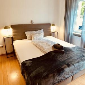 a bedroom with a large bed with a blanket on it at Mainglück in Seligenstadt