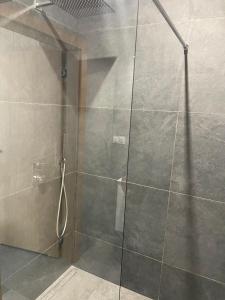 a shower with a glass door in a bathroom at Królewska 51 in Tuszyn
