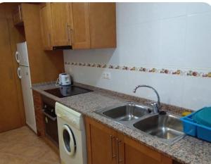 a small kitchen with a sink and a dishwasher at Casa Rural Trinquete in Montán