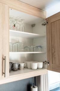 a cabinet with bowls and other dishes in it at l'hôt'antique in Vielsalm +79 photos