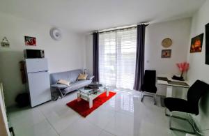 a living room with a couch and a table at APARTMÁNY I&V - Adults only in Plzeň