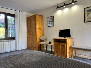 a room with a tv and a desk with a computer at Devonshire Lodge Chalet in Bansko