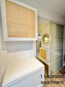 a kitchen with white cabinets and a mirror at Higueron apartment in Resort next Luxury SPA in Fuengirola