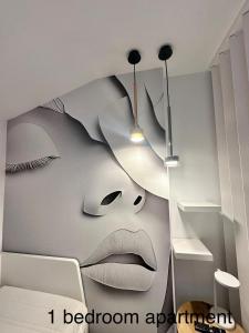 a room with a wall with a painting of a face at Higueron apartment in Resort next Luxury SPA in Fuengirola +72 photos