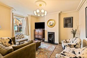 a living room with a couch and a fireplace at The Royal Paddock in Ascot