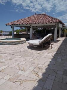 a bench in front of a gazebo at Villa Vita Oceanfront Mansion in Santa Teresita +93 photos