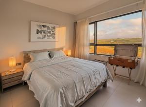 a bedroom with a large bed and a large window at Sky View Penthouse in Moka +18 photos