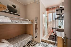 a small room with two bunk beds and a window at Vecchio Treno guest house in Tivoli
