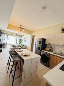 a kitchen with a island in the middle of a room at Apartment Luxury ONA Residence, Punta Cana in Punta Cana