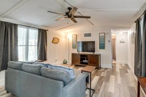 a living room with a couch and a tv at Bring Your Boat! Homosassa Retreat Less Than 5 Mi to River in Homosassa Springs