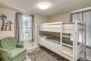 a bedroom with two bunk beds and a chair at Bring Your Boat! Homosassa Retreat Less Than 5 Mi to River in Homosassa Springs