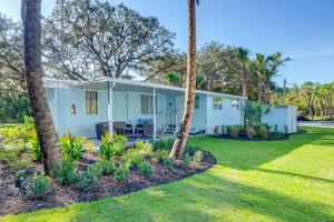 a white house with palm trees in the yard at Bring Your Boat! Homosassa Retreat Less Than 5 Mi to River in Homosassa Springs