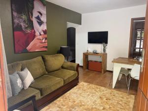a living room with a couch and a table at Casa Riacho Verde in Petrópolis