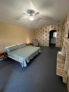 a bedroom with a bed and a ceiling fan at The Jefferson Suite in Eagle Pass