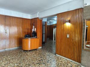 a lobby with wood paneled walls and a desk at Libertador 1 MVD in Montevideo
