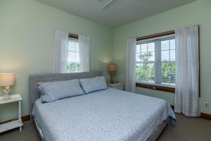 Un dormitorio con una cama y dos ventanas. en Sound Choice, en Edisto